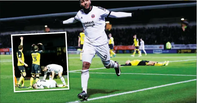  ?? PICTURES: Action Images ?? SLICED AND DICED: Leon Clarke wheels away in celebratio­n after putting Sheffield United 3-1 up at Burton. Inset: Paul Coutt lies injured