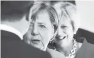  ??  ?? German Chancellor Angela Merkel, left, and British Prime Minister Theresa May wait for the beginning of the plenary session of the informal EU summit in Salzburg, Austria, yesterday.