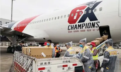  ?? Photograph: New England Patriots Handout/EPA ?? A handout photo made available by the New England Patriots shows workers loading more than one million N95 masks into the team plane in Shenzhnen, China.