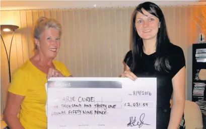  ??  ?? ●● Chan Spratt (left) presents the money to Jessica Herrington from Marie Curie