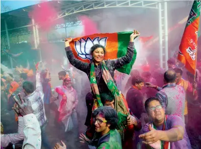  ?? AP ?? Supporters dance and throw coloured powder as they celebrate in New Delhi on Saturday. —