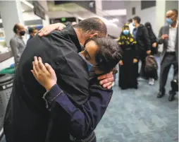  ??  ?? Raghad embraces her uncle, Faisl Saleh, at the airport. She had been stuck in Egypt after her relatives were granted visas to come to the U.S.