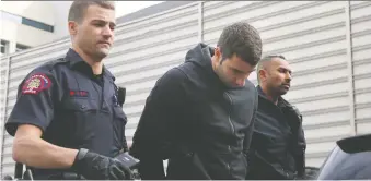  ?? LEAH HENNEL/FILES ?? Police escort Blais Delaire into the arrest processing unit in Calgary in March, 2018, after he was arrested in connection with a double-homicide of Colin Reitberger and Anees Amr in May 2017.