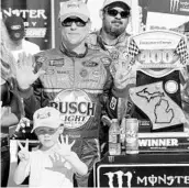 ?? JERRY MARKLAND/GETTY IMAGES ?? Kevin Harvick and son Keelan celebrate the No. 4 Ford driver’s NASCAR Cup-leading 7th victory of the season.