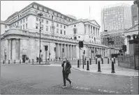  ?? ALBERTO PEZZALI AP ?? The Bank of England, in London’s financial district, raised interest rates in the United Kingdom on Thursday.