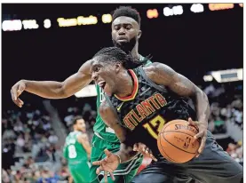  ?? David Goldman / AP ?? Atlanta’s Taurean Prince (12) moves to the hoop against Boston’s’ Jaylen Brown.