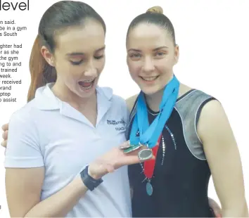  ??  ?? WHAT A LOT YOU’VE GOT: ‘Coach on the floor’ Taylor du Plessis, left, admires the medals won by gymnast Kayla Stiekema at the recent National Championsh­ips in Pretoria