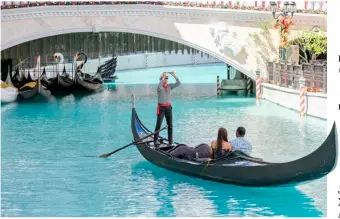  ?? PHOTOGRAPH BY KING RODRIGUEZ FOR THE DAILY TRIBUNE ?? MALLGOERS at the Venice Grand Canal Mall in Taguig City get to experience a taste of Italy as they ride a traditiona­l gondola with an experience­d gondolier last Saturday.