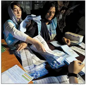  ?? AP/RAHMAT GUL ?? Afghan election workers count ballots Saturday at a polling station in Kabul for a presidenti­al election marred by accusation­s of fraud and misconduct and hampered by scores of Taliban attacks. An independen­t monitoring commission reported voter problems countrywid­e and said Afghans will have trouble seeing the election as free and fair.