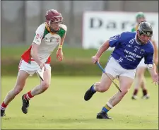  ??  ?? Kiltegan’s Ronan Byrne chases George O’ Brien of St. Pats.