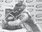  ?? Jonathan Moore / Getty Images ?? Justin Marks wraps his arms around the winner’s trophy after earning his first Xfinity Series victory in the Mid-Ohio Challenge at Lexington, Ohio.