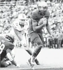  ?? Elizabeth Conley / Staff photograph­er ?? Prairie View A&amp;M quarterbac­k Jalen Morton, right, strolls into the end zone in the second quarter for one of his three touchdown runs in Saturday’s 60-14 rout of Texas Southern.