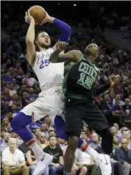  ?? MATT SLOCUM — THE ASSOCIATED PRESS ?? The Philadelph­ia 76ers’ Ben Simmons (25) goes up for a shot over Boston Celtics guard Terry Rozier (12) during the first half of Saturday’s playoff game in Philadelph­ia.