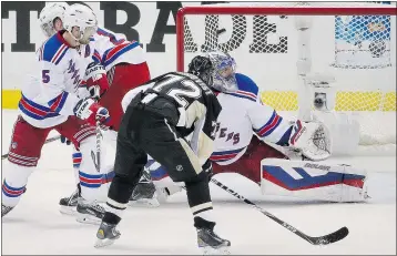  ?? — THE ASSOCIATED PRESS ?? Pittsburgh’s Patric Hornqvist gets the puck past New York’s Henrik Lundqvist for the Pens’ lone marker during the Rangers’ 2-1 win Monday night.