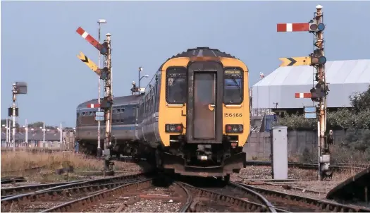  ??  ?? Having left Blackpool North’s Platform 6 under the authority of No 84 signal, the driver receives the ‘all clear’ from signal No 80. In this instance, the ‘fishtail’ distant signal would only clear when Blackpool North’s section signal No 65 was ‘off’. The short arm controlled shunt movements. For this, the route indicator mounted below can display DS (Down Siding) or US (Up Siding). 156466 is forming the 1453 to Manchester Piccadilly on August 8 2000.