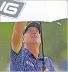  ?? CHRIS O’MEARA/THE ASSOCIATED PRESS ?? Stewart Cink puts up his umbrella as the rain begins to fall on the eighth hole Friday at the Valspar Championsh­ip at Innisbrook in Palm Harbor, Fla.