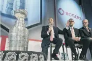  ?? AARON VINCENT ELKAIM/ GETTY IMAGES FILES ?? NHL commission­er Gary Bettman, left, announces the Rogers-NHL deal in November with Nadir Mohamed, middle, then-president and CEO, Rogers Communicat­ions, and Keith Pelley, president of Rogers Media.