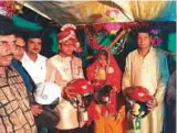  ??  ?? Shilpi Singh, the bride, giving helmets to guests during her wedding in Bihar.