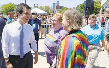  ?? Charlie Neibergall Associated Press ?? DEMOCRATIC candidate Pete Buttigieg greets people at the Capital City Pride Fest in Des Moines in June.