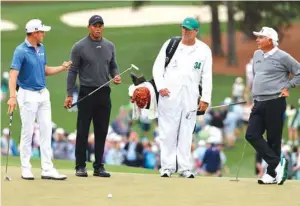  ?? (Reuters) ?? American golfers Tiger Woods (second left), Fred Couples (right) and Justin Thomas (left) are seen during a practice round at the Augusta National Golf Club, Augusta, Georgia, US.