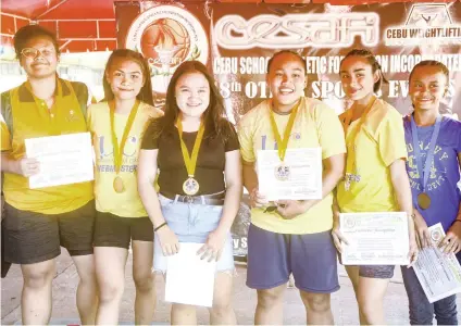  ?? ACLAO SUNSTAR FOTO / ARNI ?? ALL WINNERS. Gold medalists (from left) Helly Soza, Mary Clair Saga, Niña Abigail Patalinghu­g, Elreen Ando, RJ Polan and Kicely Lobite are all smiles after winning their division in the Cebu Schools Athletic Foundation Inc. weightlift­ing event.