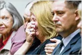  ??  ?? Kathy Olsen, wife of Robert Olsen, is consoled as Monday’s verdict is read in front of DeKalb County Superior Court Judge LaTisha Dear Jackson at the DeKalb County Courthouse.