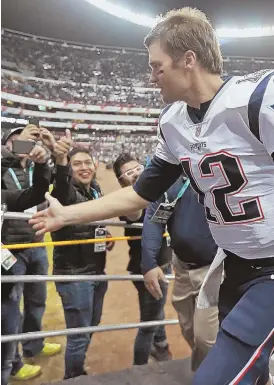  ?? STAFF FILE PHOTO BY MATT STONE ?? READY TO EXIT? Tom Brady greets fans following last year’s game in Mexico City, but Patriots faithful still are left to wonder whether they will be seeing the quarterbac­k on the field this season.