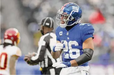  ?? Elsa/TNS ?? Saquon Barkley (26) of the New York Giants at MetLife Stadium on Jan. 9, 2022, in East Rutherford, N.J. The Giants put the franchise tag on Barkley. Next on the agenda is getting Barkley a long-term deal.