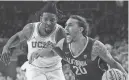  ?? MARK J. TERRILL/AP ?? California guard Jaylon Tyson, right, drives to the basket as UCLA forward Kenneth Nwuba defends during the first half on Saturday in Los Angeles.