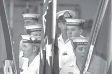  ?? AGENCE FRANCE PRESSE ?? Sailors from the Royal Australian Navy stand behind flags aboard the Australian Navy ship HMAS Canberra in Sydney on February 20, 2024.