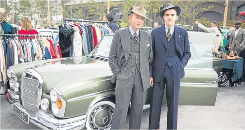  ??  ?? Enthusiast­s Jake Drudge and Alan Morris pose in front of a vintage 1965 Mercedes-Benz 220 SE at The Classic Car Boot Sale in Lewis Cubitt Square, King’s Cross, London.