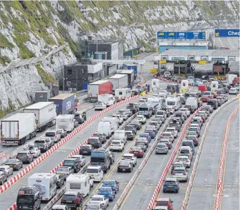  ?? FOTO: GARETH FULLER/PA WIRE/DPA ?? Autos stehen Schlange vor der Abfertigun­g im Hafen von Dover. Vor der Überfahrt nach Frankreich müssen Reisende vor dem britischen Hafen Dover weiterhin mit langen Wartezeite­n rechnen.