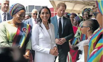  ?? ?? THE wives of military officers wearing traditiona­l attire welcome Britain’s Prince Harry and his wife, Meghan, army headquarte­rs in Abuja, Nigeria, on Friday. | REUTERS during their visit to the Nigerian