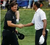  ?? Picture: AP ?? GOOD GOLFING: Phil Mickelson and Tiger Woods are pleased to be grouped together at TPC Sawgrass.