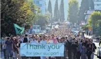  ??  ?? Solidarity and support . . . More than 10,000 students and staff, led by members of the Muslim community, march in silence from the University of Otago down Union St East towards Forsyth Barr Stadium yesterday.