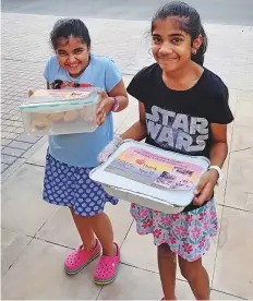  ??  ?? Sisters Krishaana and Miraaya Rajagopala­n, students of the Safa Community School, took it upon themselves to lend a helping hand to the flood victims in their own little way.