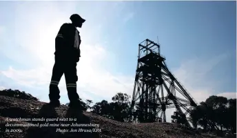  ??  ?? A watchman stands guard next to a decommissi­oned gold mine near Johannesbu­rg in 2009. Photo: Jon Hrusa/EPA