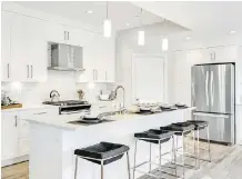  ?? PHOTOS: STREETSIDE DEVELOPMEN­TS ?? The kitchen in the Clare floor plan gleams at Killarney Townes, a boutique townhome developmen­t.