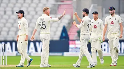  ?? Picture: PA. ?? Ben Stokes is congratula­ted after taking the wicket of Shaheen Shah Afridi.