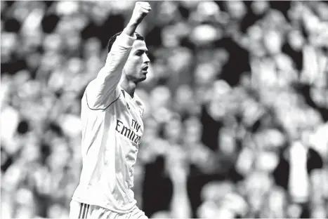  ?? AP PHOTO/ ?? REAL MADRID’S Cristiano Ronaldo celebrates after scoring his side’s third goal against Sevilla during the Spanish La Liga soccer match between Real Madrid and Sevilla at the Santiago Bernabeu stadium in Madrid, Saturday, Dec. 9, 2017. Ronaldo scored...