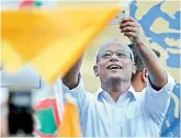  ??  ?? Ibrahim Mohamed Solih, the president-elect of the Maldives, takes a selfie as he interacts with supporters during a gathering in Male on Monday. –AP