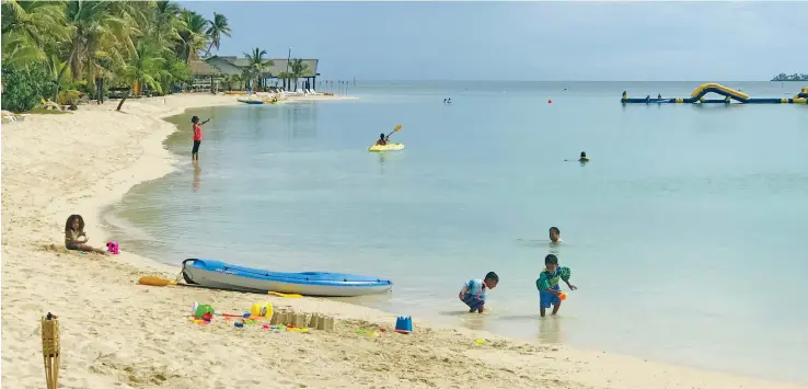  ?? Photo: Charles Chambers ?? Locals enjoying the immaculate beach and sea at Plantation Island Resort on June 27.