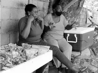  ?? PHOTOS BY NICHOLAS NUNES/PHOTOGRAPH­ER ?? Vie Porteous (left) lost her livelihood because of COVID-19, while Millicent Davis remains the sole vendor at Yallahs Primary School in St Thomas.