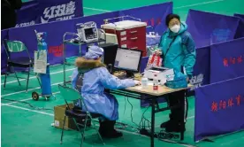  ?? Wu Hao/EPA ?? A doctor prescribes medicine for a patient at a makeshift fever clinic in Beijing. Photograph: