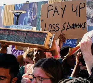  ?? Peter Dejong/Associated Press file photo ?? A clock shows time left before the world uses up emissions while staying at or below a warming goal during a protest at last month’s climate summit in Sharm el-Sheikh, Egypt.