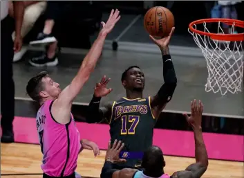  ?? AP Photo/Marta Lavandier ?? Los Angeles Lakers guard Dennis Schroder (17) drives to the basket as Miami Heat guard Goran Dragic (7) defends, during the first half of an NBA basketball game, on Thursday in Miami.