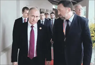  ?? Mikhail Klimentyev Associated Press ?? RUSSIAN PRESIDENT Vladimir Putin with metals magnate Oleg Deripaska, who is among those affected by the sanctions. Deripaska had ties with President Trump’s onetime campaign Chairman Paul Manafort.