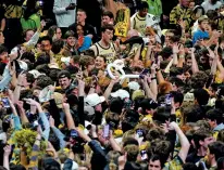  ?? CHUCK BURTON/THE ASSOCIATED PRESS ?? Wake Forest’s Matthew Marsh, above center, celebrates with fans Saturday after his team’s win over Duke in North Carolina.