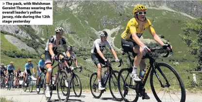  ??  ?? &gt; The pack, with Welshman Geraint Thomas wearing the overall leader’s yellow jersey, ride during the 12th stage yesterday