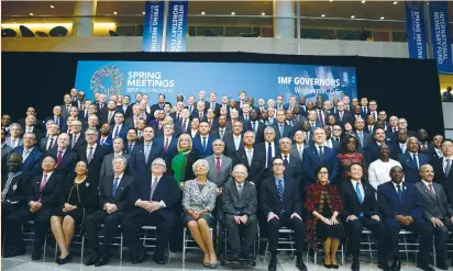  ?? (Mike Theiler/Reuters) ?? FINANCE MINISTERS and bank governors pose for a group photo of the Internatio­nal Monetary and Financial Committee at the Internatio­nal Monetary Fund and World Bank annual spring meetings in Washington on Saturday.